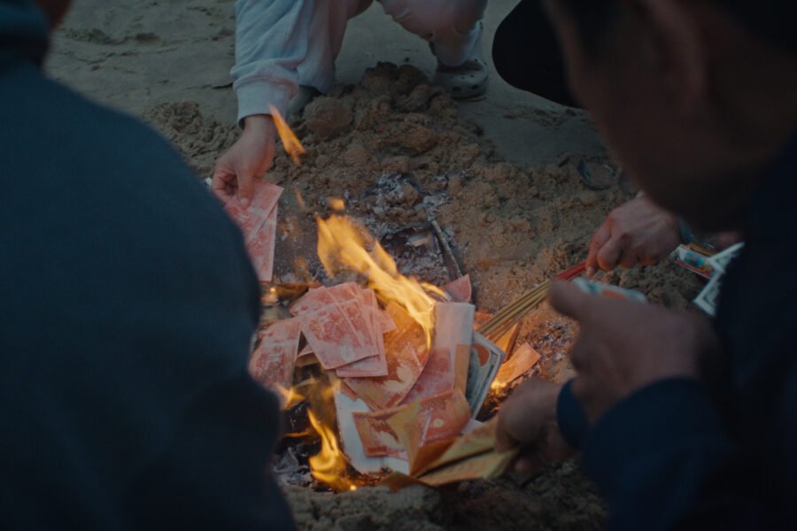A joss paper burning ritual in Still Night, Burning House