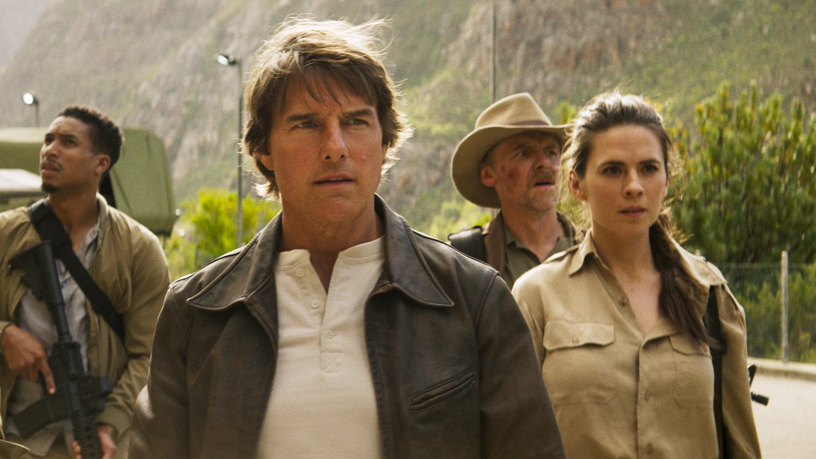 Tom Cruise as Ethan Hunt with Hayley Atwell and Greg Tarzan Davis on a mountain road in Mission: Impossible The Final Reckoning